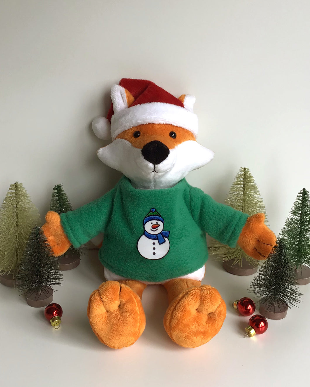 Handmade festive fox soft toy. Made with Shannon cuddle soft solid fabric and wearing a fleece Christmas jumper.