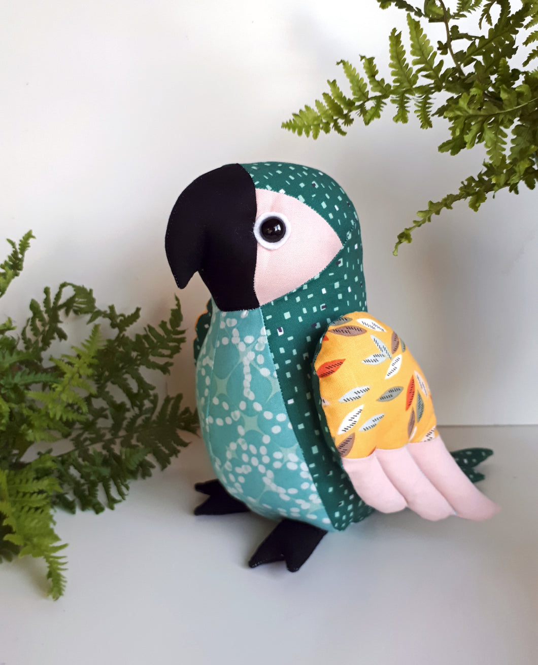 Handmade parrot soft toy made with bright tropical style fabrics
